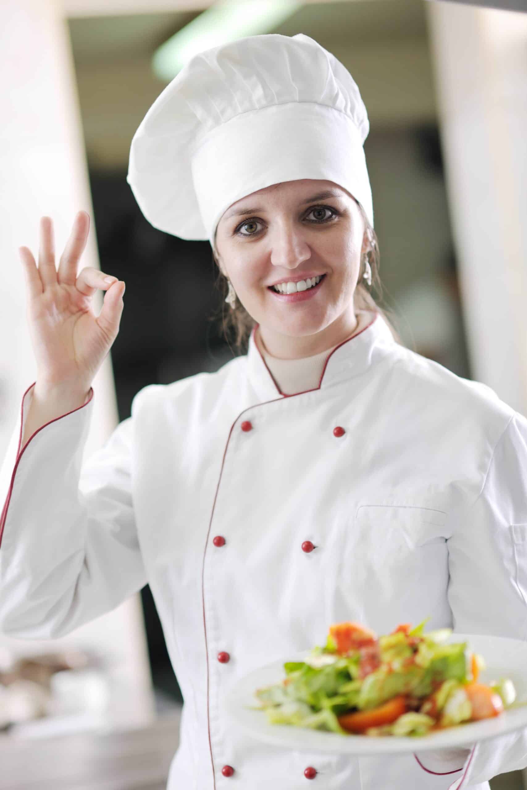 Bella Hartte smiling and giving OK gesture while holding a fresh salad
